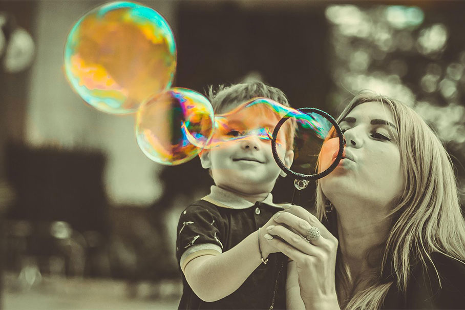 Mother and son blowing bubbles