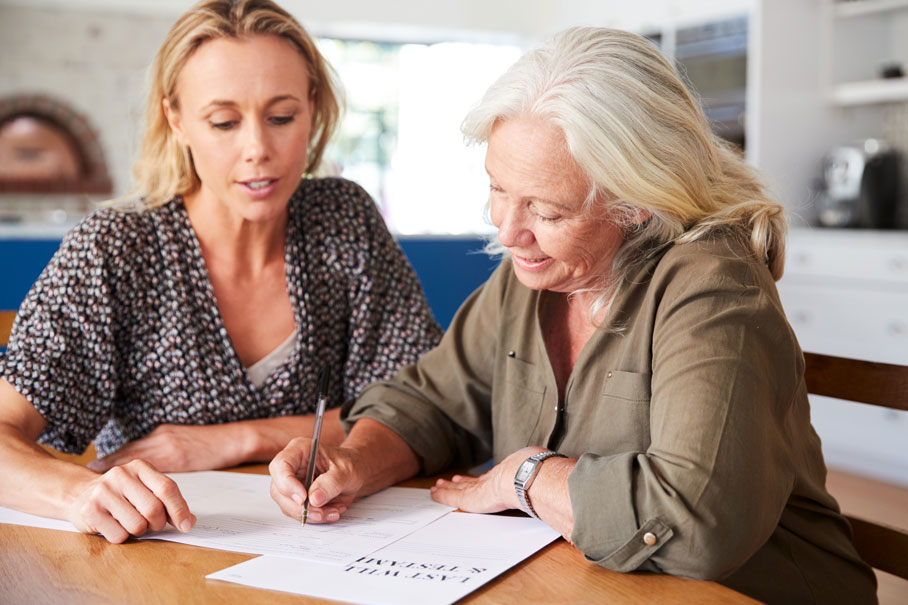 Two ladies making a Will with a template